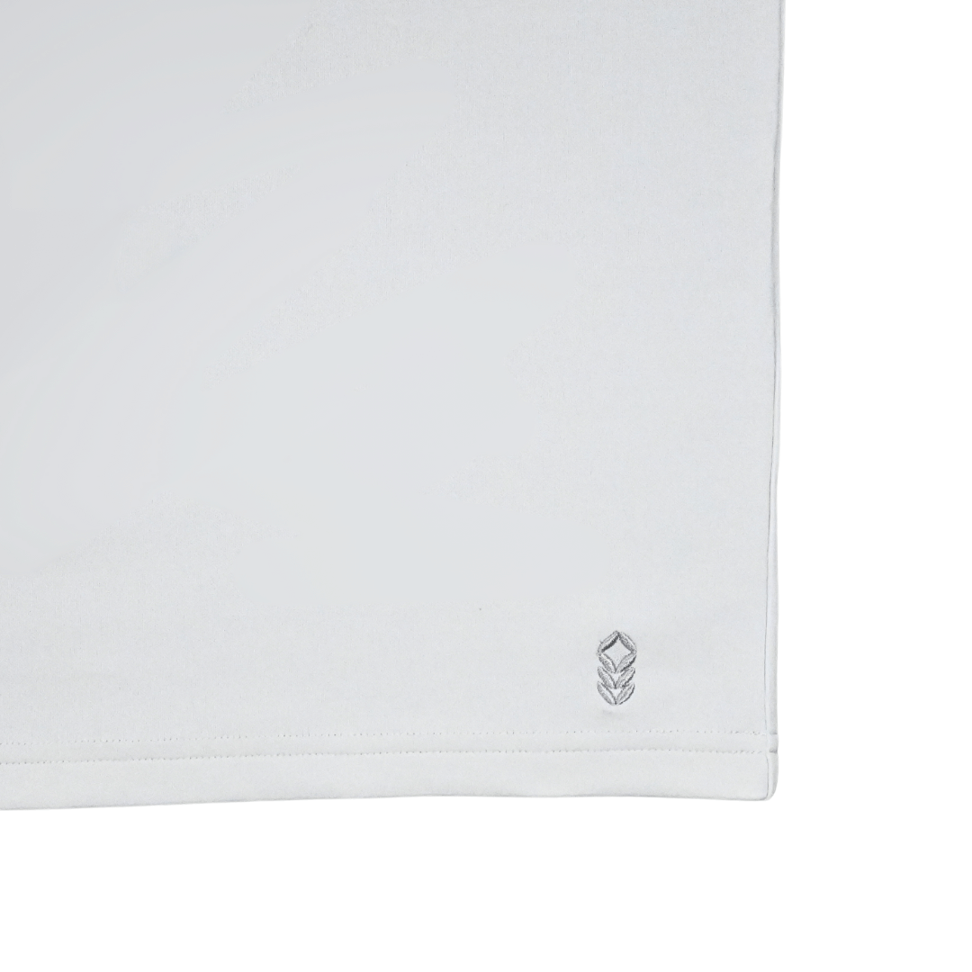 Maverick Tee displayed flat on a neutral surface – minimal, clean activewear design made with non-toxic materials and low-impact dyes