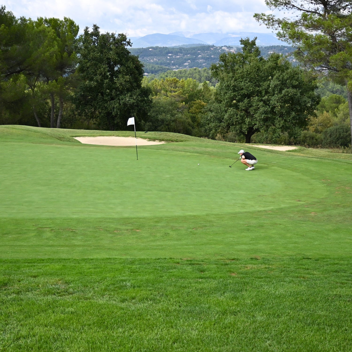 Patron golfer lining up their birdie putt to win their match.
